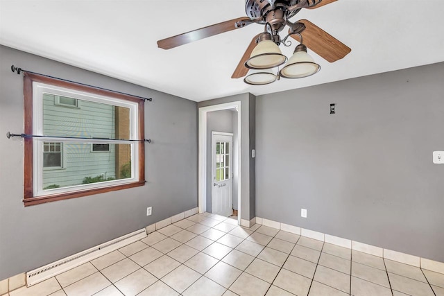 1945 Eastman Ave, Green Bay, WI 54302 - spare room featuring a ceiling fan, baseboards, light tile patterned floors, and a baseboard heating unit