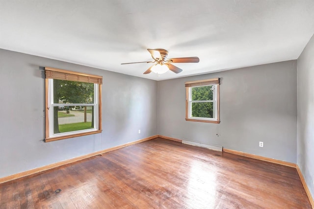 1945 Eastman Ave, Green Bay, WI 54302 - spare room featuring a baseboard radiator, wood finished floors, baseboards, and ceiling fan