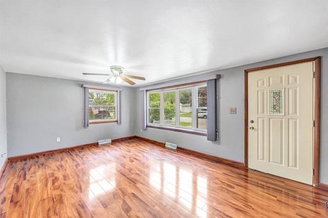 1945 Eastman Ave, Green Bay, WI 54302 - empty room with ceiling fan, light wood finished floors, and baseboards