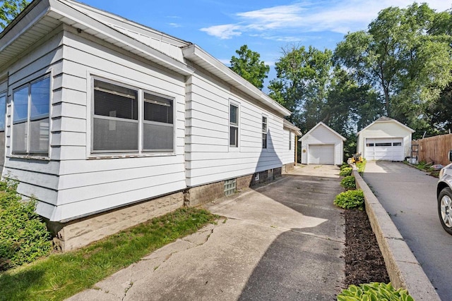 310 W Edgewater St, Portage, WI 53901 - view of property exterior featuring a detached garage