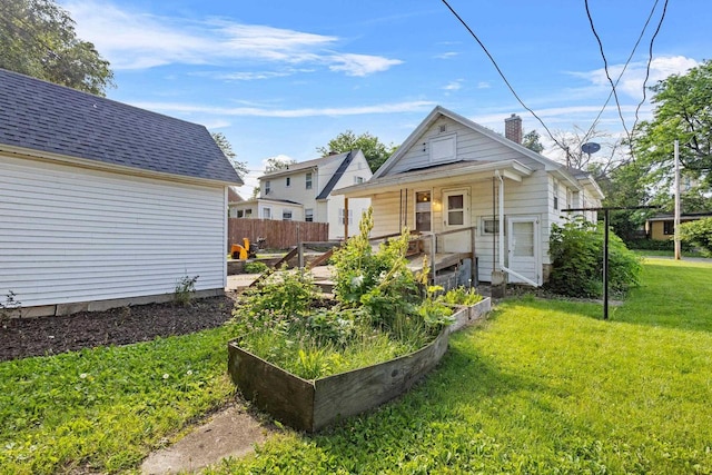 310 W Edgewater St, Portage, WI 53901 - back of property with a garden and a chimney