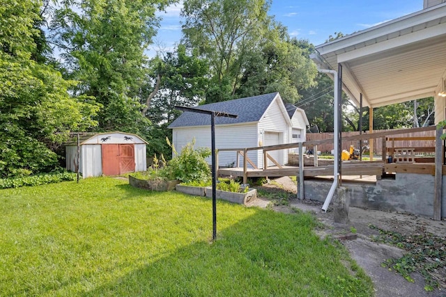 310 W Edgewater St, Portage, WI 53901 - view of yard with a storage unit, a detached garage, and a wooden deck