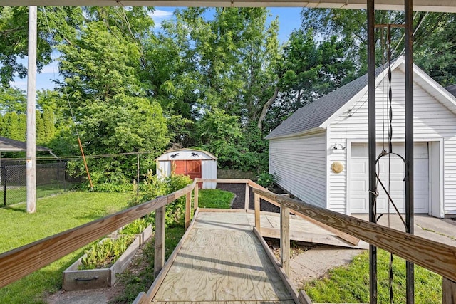 310 W Edgewater St, Portage, WI 53901 - deck featuring a vegetable garden, a shed, and view of scattered trees