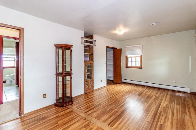 N2594 State Road 76, Hortonville, WI 54944 - unfurnished bedroom with a baseboard radiator and wood finished floors