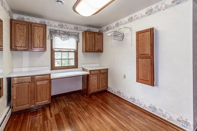 N2594 State Road 76, Hortonville, WI 54944 - kitchen featuring brown cabinets, dark wood-type flooring, light countertops, and a baseboard heating unit