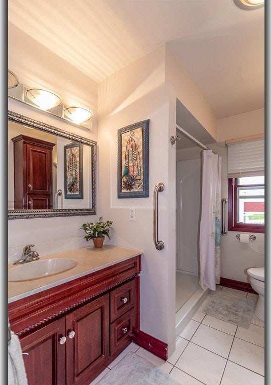 N2594 State Road 76, Hortonville, WI 54944 - full bath with vanity, a stall shower, tile patterned floors, toilet, and baseboards