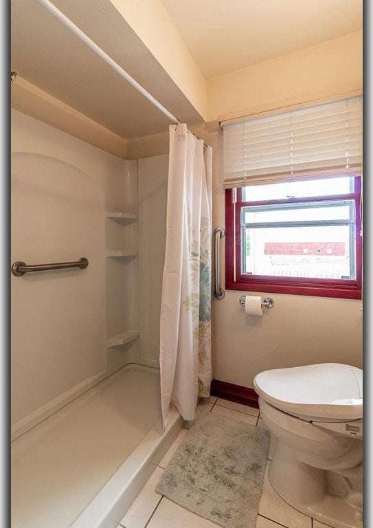 N2594 State Road 76, Hortonville, WI 54944 - full bathroom featuring tile patterned flooring, a stall shower, and toilet
