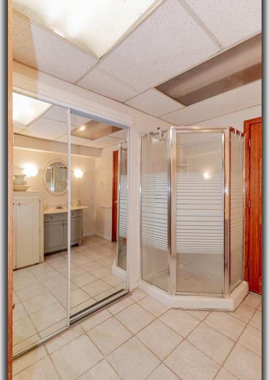 N2594 State Road 76, Hortonville, WI 54944 - full bath with vanity, tile patterned floors, and a stall shower