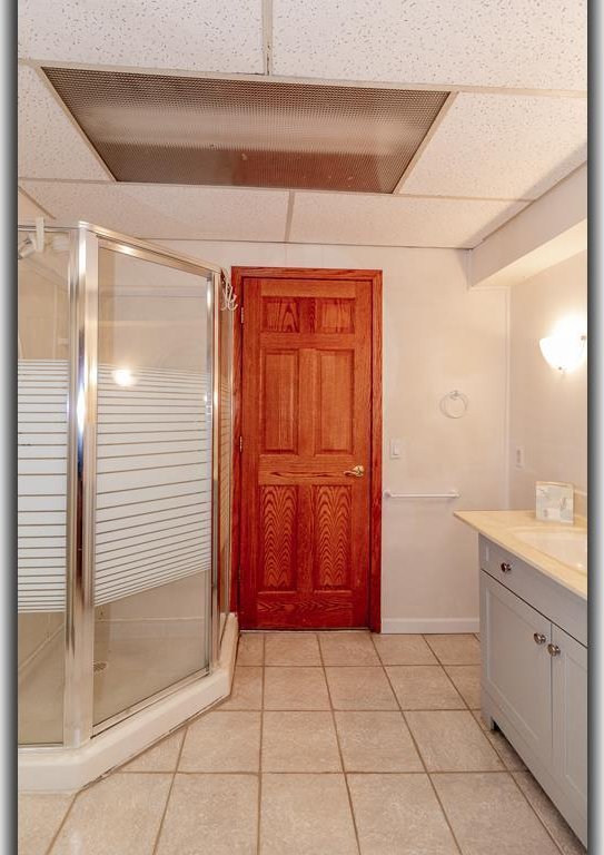 N2594 State Road 76, Hortonville, WI 54944 - full bathroom with vanity, a stall shower, and tile patterned floors