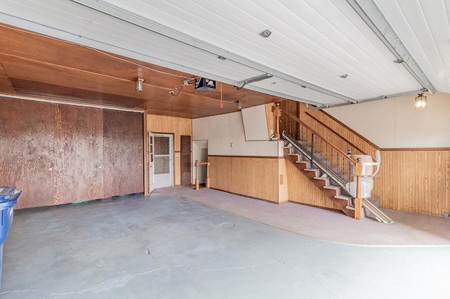 N2594 State Road 76, Hortonville, WI 54944 - garage with wooden walls, a garage door opener, and a wainscoted wall