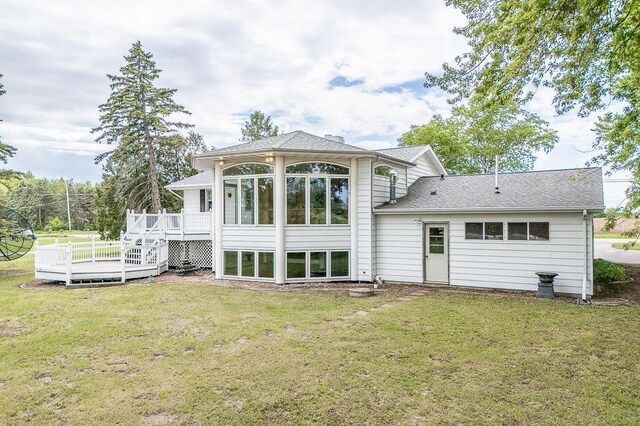 N2594 State Road 76, Hortonville, WI 54944 - back of house with a wooden deck, a lawn, a sunroom, and roof with shingles