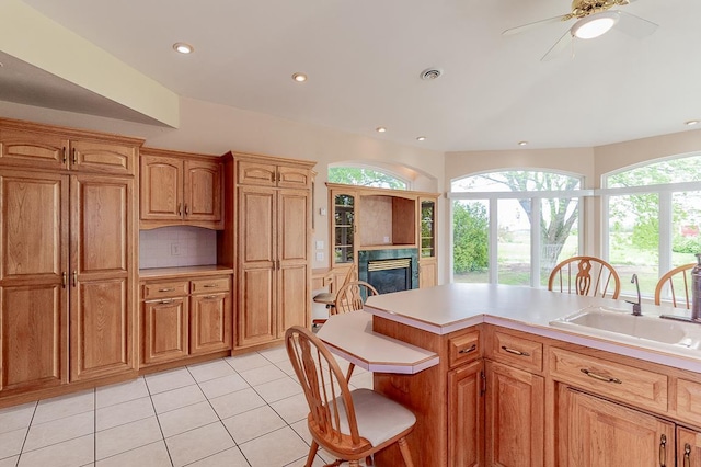 N2594 State Road 76, Hortonville, WI 54944 - kitchen featuring a sink, plenty of natural light, a fireplace, light tile patterned floors, and recessed lighting