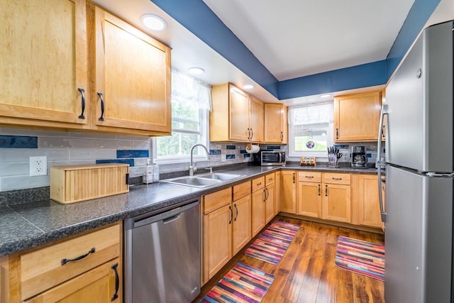 201 N 3rd St, Colby, WI 54421 - kitchen with appliances with stainless steel finishes, a sink, wood finished floors, light brown cabinetry, and backsplash