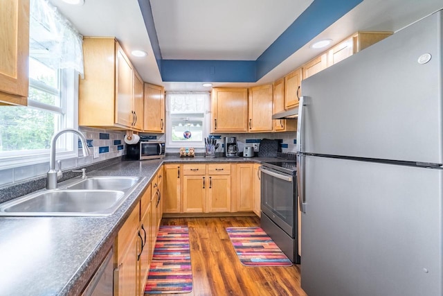 201 N 3rd St, Colby, WI 54421 - kitchen featuring stainless steel appliances, a sink, under cabinet range hood, light brown cabinetry, and recessed lighting