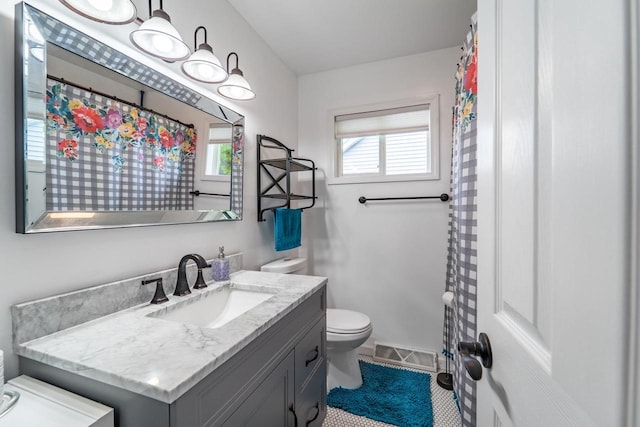 201 N 3rd St, Colby, WI 54421 - bathroom with toilet, vanity, plenty of natural light, and tile patterned flooring
