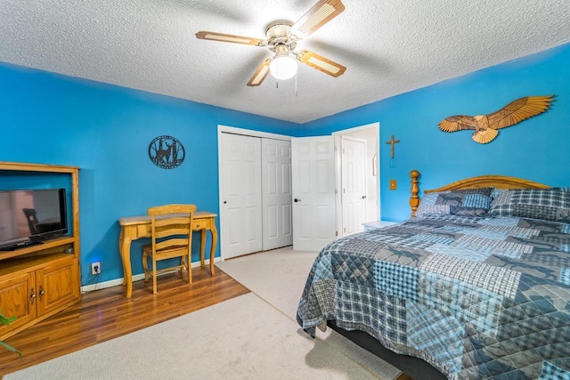 201 N 3rd St, Colby, WI 54421 - bedroom with a textured ceiling, a closet, carpet flooring, ceiling fan, and wood finished floors