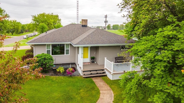 201 N 3rd St, Colby, WI 54421 - view of front of house with a shingled roof, a front lawn, and a deck