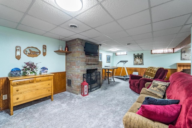 201 N 3rd St, Colby, WI 54421 - living room with wooden walls, a paneled ceiling, carpet floors, wainscoting, and a fireplace