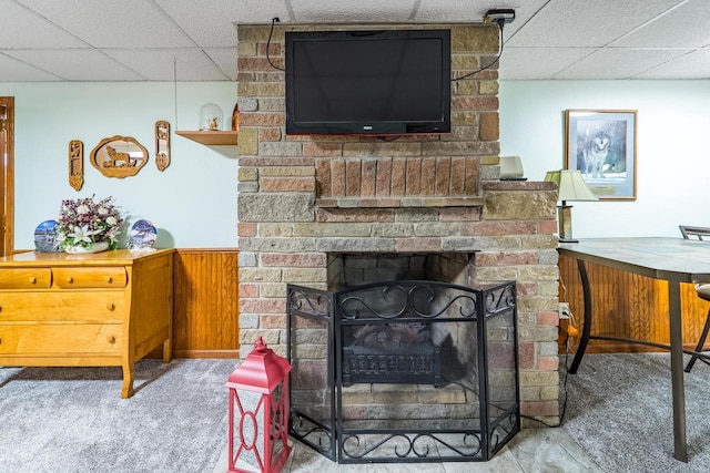 201 N 3rd St, Colby, WI 54421 - carpeted living area featuring a drop ceiling, wainscoting, and a brick fireplace