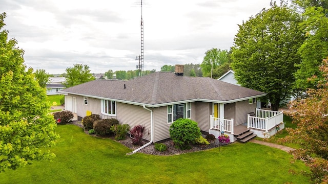 201 N 3rd St, Colby, WI 54421 - rear view of property featuring roof with shingles, a lawn, a chimney, and a wooden deck