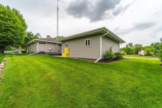 201 N 3rd St, Colby, WI 54421 - rear view of house featuring a yard and central AC