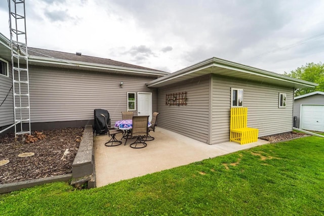 201 N 3rd St, Colby, WI 54421 - back of house featuring a patio, a lawn, and an outdoor structure