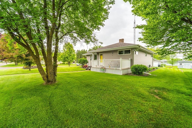 201 N 3rd St, Colby, WI 54421 - back of property featuring a chimney, a yard, and a deck