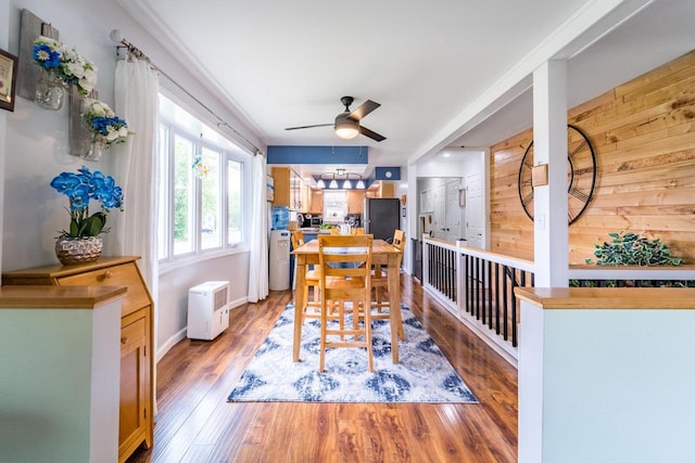 201 N 3rd St, Colby, WI 54421 - dining area featuring ceiling fan, wooden walls, and light wood-style flooring