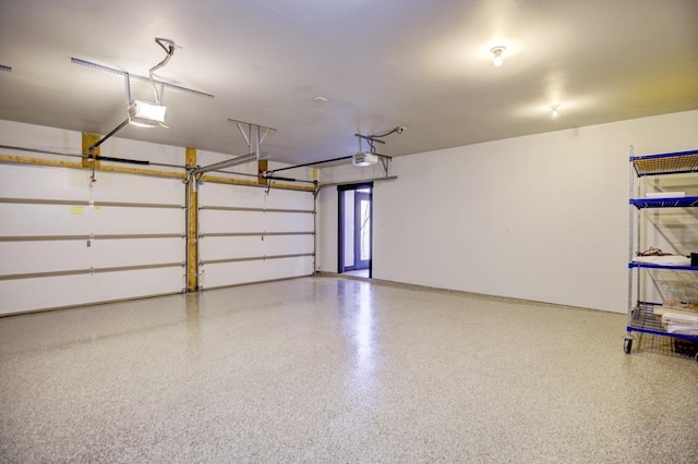 508 Frost Woods Rd, Monona, WI 53716 - garage featuring a garage door opener and baseboards