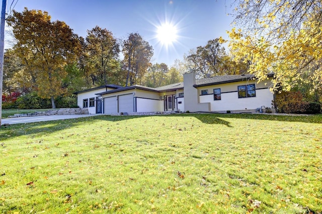 508 Frost Woods Rd, Monona, WI 53716 - view of front of house featuring an attached garage, a front yard, driveway, and a chimney