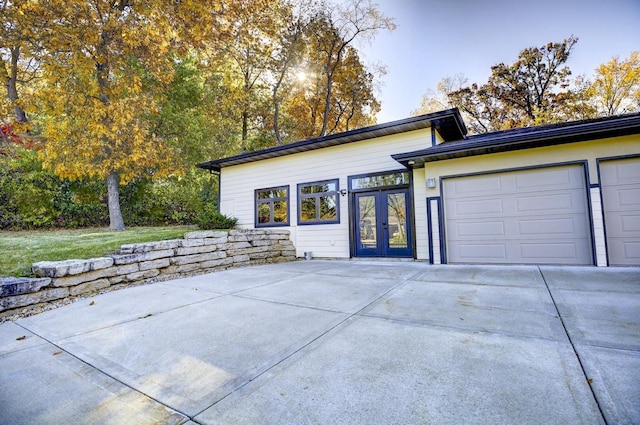 508 Frost Woods Rd, Monona, WI 53716 - view of front facade featuring concrete driveway, french doors, and a garage