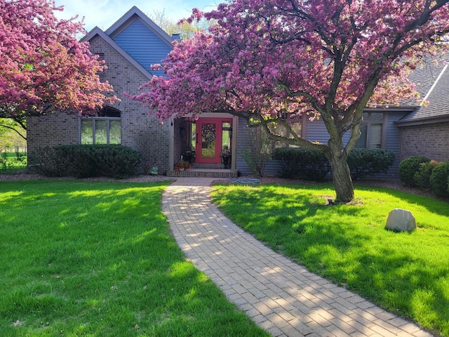 W313N4961 Chapel Ridge Rd, Hartland, WI 53029 - view of front of house with brick siding and a front lawn