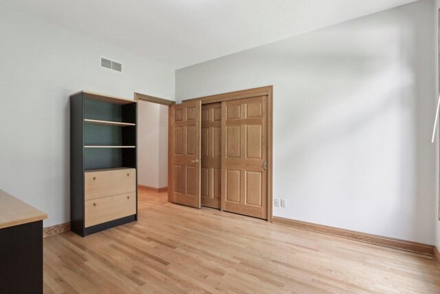 W313N4961 Chapel Ridge Rd, Hartland, WI 53029 - unfurnished bedroom with light wood-type flooring, baseboards, and a closet