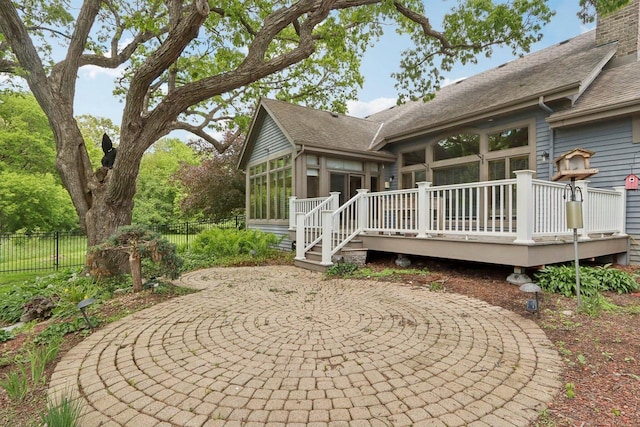 W313N4961 Chapel Ridge Rd, Hartland, WI 53029 - view of side of property with a sunroom, a wooden deck, a patio area, and a shingled roof