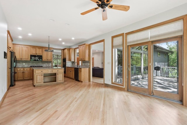 W313N4961 Chapel Ridge Rd, Hartland, WI 53029 - kitchen with black appliances, a sink, tasteful backsplash, light wood-style floors, and open shelves