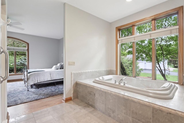 W313N4961 Chapel Ridge Rd, Hartland, WI 53029 - bathroom featuring a bath, a ceiling fan, baseboards, and ensuite bathroom