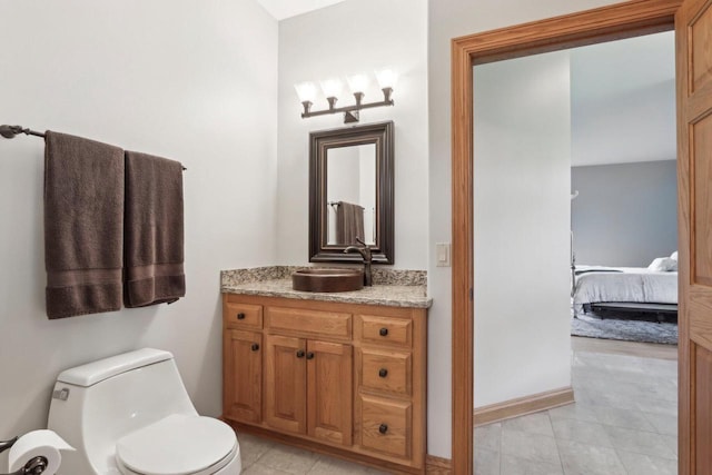 W313N4961 Chapel Ridge Rd, Hartland, WI 53029 - ensuite bathroom with toilet, vanity, tile patterned floors, and baseboards