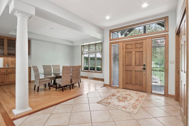 W313N4961 Chapel Ridge Rd, Hartland, WI 53029 - foyer with ornate columns, healthy amount of natural light, light tile patterned floors, baseboards, and recessed lighting