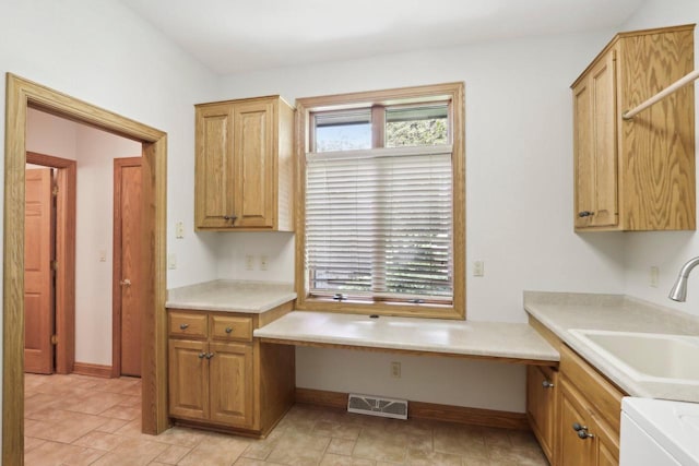 W313N4961 Chapel Ridge Rd, Hartland, WI 53029 - kitchen featuring a sink, light countertops, and baseboards