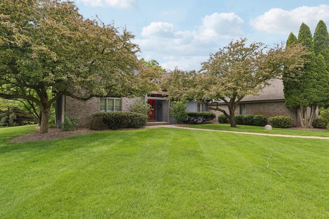 W313N4961 Chapel Ridge Rd, Hartland, WI 53029 - view of front of home with a front yard and brick siding