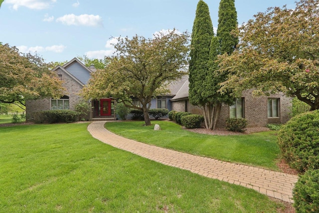 W313N4961 Chapel Ridge Rd, Hartland, WI 53029 - view of property hidden behind natural elements featuring brick siding and a front yard