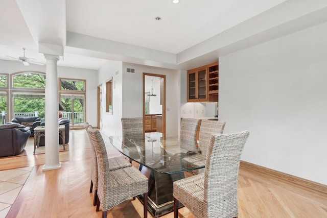 W313N4961 Chapel Ridge Rd, Hartland, WI 53029 - dining space featuring decorative columns, light wood-style floors, baseboards, and ceiling fan