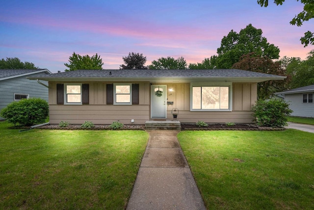 116 Woodward St, Fond Du Lac, WI 54935 - single story home with board and batten siding, a front lawn, and roof with shingles