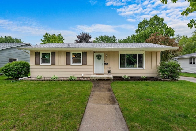 116 Woodward St, Fond Du Lac, WI 54935 - ranch-style home featuring board and batten siding, a front lawn, and a shingled roof