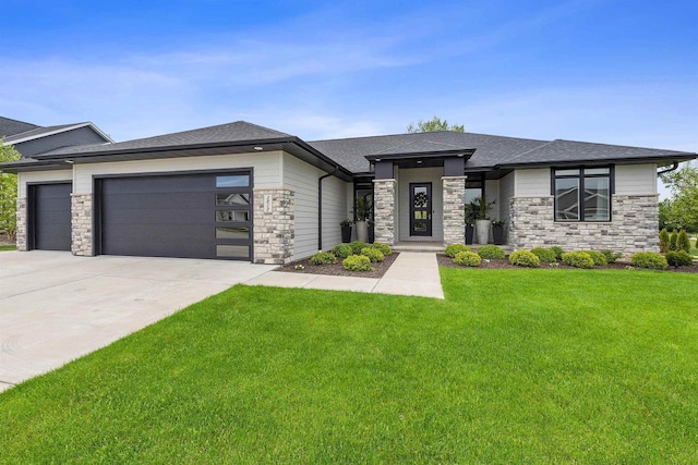 3812 Hawk Ledge Cir, De Pere, WI 54115 - prairie-style house with stone siding, a garage, a front yard, driveway, and a shingled roof
