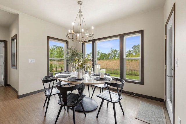 3812 Hawk Ledge Cir, De Pere, WI 54115 - dining room featuring light wood-style floors, baseboards, and a chandelier