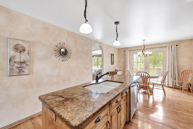 5125 Finger Rd, Green Bay, WI 54311 - kitchen featuring a sink, arched walkways, light wood-type flooring, dishwasher, and a center island with sink