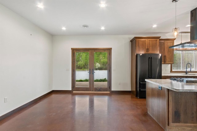 7947 Victoria Ct, Hewitt, WI 54441 - kitchen featuring freestanding refrigerator, french doors, concrete floors, baseboards, and stainless steel gas cooktop