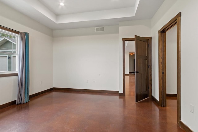 7947 Victoria Ct, Hewitt, WI 54441 - unfurnished room featuring baseboards, a tray ceiling, and finished concrete flooring