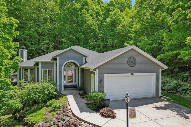 16625 Tanglewood Dr, Brookfield, WI 53005 - view of front of house featuring a shingled roof, a chimney, driveway, and a garage